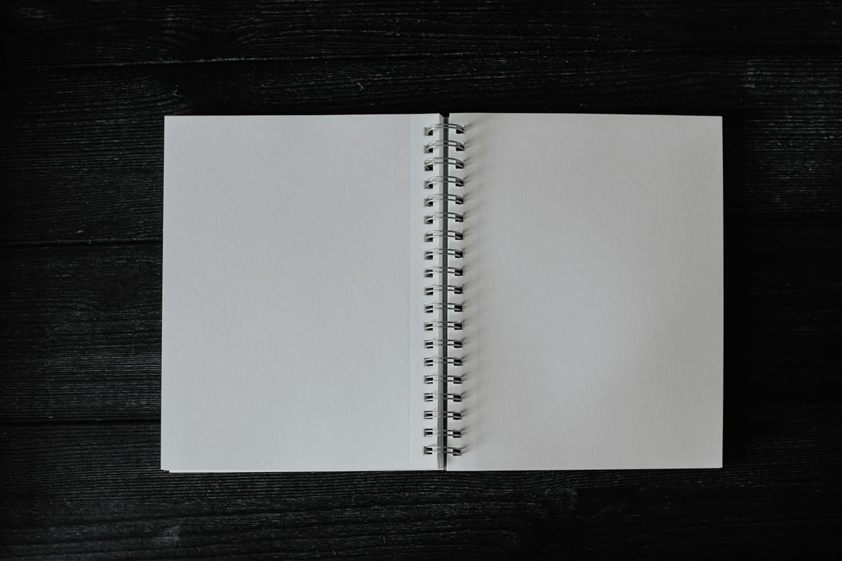 an open notebook on a wooden table